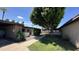 Exterior view of a well-maintained property with mature trees and walkways at 220 S Old Litchfield Rd # 104, Litchfield Park, AZ 85340