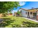 Expansive backyard with lush greenery, a charming patio, and a well-maintained lawn perfect for entertaining and relaxation at 2230 N Los Alamos --, Mesa, AZ 85213