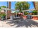 Beautiful backyard with outdoor dining space, built-in grill and pizza oven surrounded by lush trees and blue sky at 2230 N Los Alamos --, Mesa, AZ 85213