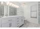Bright bathroom featuring a double vanity, hexagon tile floor, and a frameless glass shower with marbled tile at 2230 N Los Alamos --, Mesa, AZ 85213