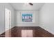 Bright bedroom with hardwood floors, ceiling fan, and a view of the outdoor greenery through the window at 2230 N Los Alamos --, Mesa, AZ 85213