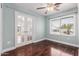 Bright bedroom featuring French doors with a view, a ceiling fan, and a large window at 2230 N Los Alamos --, Mesa, AZ 85213
