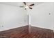 Minimalist bedroom with hardwood floors, ceiling fan, and a door leading to an ensuite bathroom at 2230 N Los Alamos --, Mesa, AZ 85213