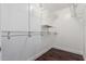 Walk-in closet providing ample shelving and hanging storage space, complemented by wood floors at 2230 N Los Alamos --, Mesa, AZ 85213