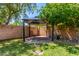 Backyard gazebo featuring brick pavers with lush green grass and trees creating the perfect private outdoor space at 2230 N Los Alamos --, Mesa, AZ 85213