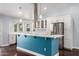 Charming kitchen with stainless steel appliances, blue island, and white cabinets for a modern aesthetic at 2230 N Los Alamos --, Mesa, AZ 85213