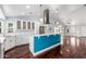 Modern kitchen with white cabinets, stainless steel appliances, breakfast bar, and hardwood floors flowing into living area at 2230 N Los Alamos --, Mesa, AZ 85213