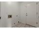 Practical laundry room features white walls, tiled floor, and utility connections at 2230 N Los Alamos --, Mesa, AZ 85213