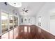 Open living room with hardwood floors, bay windows, and glass doors creating a seamless indoor-outdoor connection at 2230 N Los Alamos --, Mesa, AZ 85213