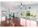 Bright open-concept living area with hardwood floors, ceiling fan, and sliding glass doors to the backyard at 2230 N Los Alamos --, Mesa, AZ 85213