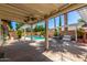 Inviting covered patio area featuring a swimming pool, pergola, and outdoor seating for relaxation and entertainment at 2230 N Los Alamos --, Mesa, AZ 85213