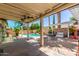 Inviting covered patio area featuring a swimming pool, pergola, and outdoor seating for relaxation and entertainment at 2230 N Los Alamos --, Mesa, AZ 85213
