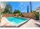 Sparkling pool with a well-maintained pool deck, set against lush landscaping and a clear blue sky at 2230 N Los Alamos --, Mesa, AZ 85213