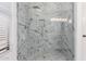 This shower stall is tiled with marbled tile, and it also has a glass door and showerhead at 2230 N Los Alamos --, Mesa, AZ 85213