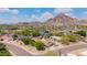 Aerial view of property with a sparkling pool and mountain views in the backdrop at 2234 E Lawrence Rd, Phoenix, AZ 85016