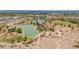 Scenic aerial view of a neighborhood park showcasing a lake, playgrounds, and green spaces perfect for recreation at 2234 E Lawrence Rd, Phoenix, AZ 85016