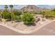 Eye-level front yard showcasing the desert landscape and an inviting entrance with palm trees at 2234 E Lawrence Rd, Phoenix, AZ 85016