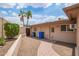 Backyard exterior of the home featuring desert landscaping and a secure backyard door at 2234 E Lawrence Rd, Phoenix, AZ 85016