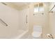 Clean bathroom featuring a shower/tub combo, toilet, grab bars and a window at 2234 E Lawrence Rd, Phoenix, AZ 85016