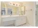 Bright bathroom featuring a double sink vanity, ample lighting and neutral color palette at 2234 E Lawrence Rd, Phoenix, AZ 85016