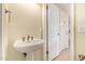 Elegant bathroom with pedestal sink and classic fixtures near additional closet space at 2234 E Lawrence Rd, Phoenix, AZ 85016