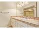 Well-lit bathroom featuring a double sink vanity with decorative tile and white cabinetry at 2234 E Lawrence Rd, Phoenix, AZ 85016