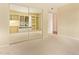 Bedroom featuring built-in shelving, a window seat, mirrored closet and neutral carpet at 2234 E Lawrence Rd, Phoenix, AZ 85016