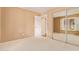 Bedroom featuring neutral walls, carpet, a mirrored closet and standard lighting at 2234 E Lawrence Rd, Phoenix, AZ 85016