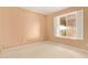 Bedroom featuring a bright window, neutral carpet and light-colored walls at 2234 E Lawrence Rd, Phoenix, AZ 85016