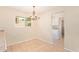 Cozy dining area with tiled floor, chandelier, and natural light from the window at 2234 E Lawrence Rd, Phoenix, AZ 85016