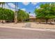 Charming single-story home with desert landscaping and mature trees, creating a welcoming curb appeal at 2234 E Lawrence Rd, Phoenix, AZ 85016