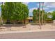Inviting single-story home with desert landscaping, mature trees and a well-kept front yard at 2234 E Lawrence Rd, Phoenix, AZ 85016