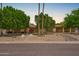 Charming single-story home featuring desert landscaping, mature trees, and a welcoming entrance at 2234 E Lawrence Rd, Phoenix, AZ 85016