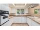 Charming kitchen with white cabinetry, tile countertops, and ample natural light at 2234 E Lawrence Rd, Phoenix, AZ 85016