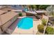 Aerial view of a private pool with shaded pergola, surrounded by lush greenery and fenced yard at 2234 E Lawrence Rd, Phoenix, AZ 85016
