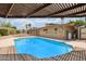 A large swimming pool, adjacent to a covered deck and shed at 2234 E Lawrence Rd, Phoenix, AZ 85016