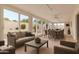 Bright sun room with walls of windows, comfortable seating, and an inviting space for relaxation and entertainment at 2234 E Lawrence Rd, Phoenix, AZ 85016
