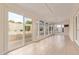 Bright sunroom featuring tiled floors, multiple windows, and sliding glass door to the exterior patio at 2234 E Lawrence Rd, Phoenix, AZ 85016