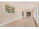 Spacious sunroom with multiple windows, tiled flooring, and bright, neutral decor at 2234 E Lawrence Rd, Phoenix, AZ 85016