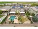 Aerial view of a beautiful home showcasing a backyard pool, lush landscaping, and a solar panel array at 22737 N Sunset Dr, Maricopa, AZ 85139