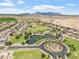 An aerial view of the community highlighting the neighborhood park, lake, landscaping, and mountain views at 22737 N Sunset Dr, Maricopa, AZ 85139