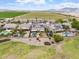 This aerial view showcases the backyard pool and the community's lush green spaces at 22737 N Sunset Dr, Maricopa, AZ 85139