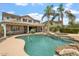 Stunning backyard with a sparkling pool, spa, lush landscaping, and a spacious patio, perfect for outdoor living at 22737 N Sunset Dr, Maricopa, AZ 85139