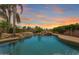 Inviting backyard pool featuring a rock waterfall, lush greenery, and a serene atmosphere, perfect for relaxation at 22737 N Sunset Dr, Maricopa, AZ 85139