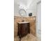 Charming powder room with a decorative mirror and stone accents at 22737 N Sunset Dr, Maricopa, AZ 85139