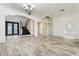 Bright foyer with tile floors, a staircase with dark wood, and a modern home elevator at 22737 N Sunset Dr, Maricopa, AZ 85139