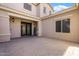 Charming home exterior featuring a custom front door, manicured landscaping, and a welcoming paver driveway at 22737 N Sunset Dr, Maricopa, AZ 85139