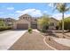 Beautiful two-story home featuring a well-manicured lawn, desert landscaping, and an attached two-car garage at 22737 N Sunset Dr, Maricopa, AZ 85139