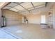 A spacious two-car garage featuring a high ceiling, shelving, and ample storage space, ideal for organization at 22737 N Sunset Dr, Maricopa, AZ 85139