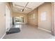 An empty two-car garage featuring tile flooring and ample storage space, offering a blank canvas for personalization at 22737 N Sunset Dr, Maricopa, AZ 85139